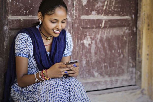 Indian girl sending a message phone