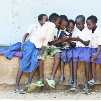 School kids from Tanzania, enjoying the internet on a tablet