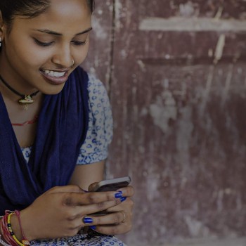 Indian girl, sitting with phone, on the internet