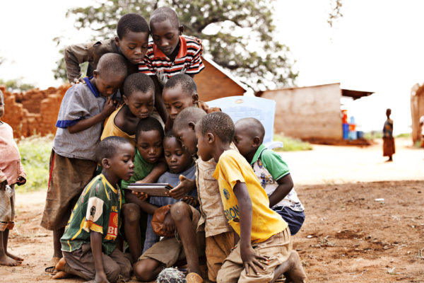 Children from Tanzania, enjoying the internet on a tablet