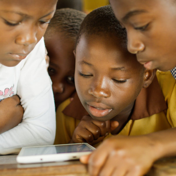 Kids from Ghana learning math online on a tablet