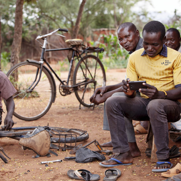 Tanzanian men having looking at sports on the internet