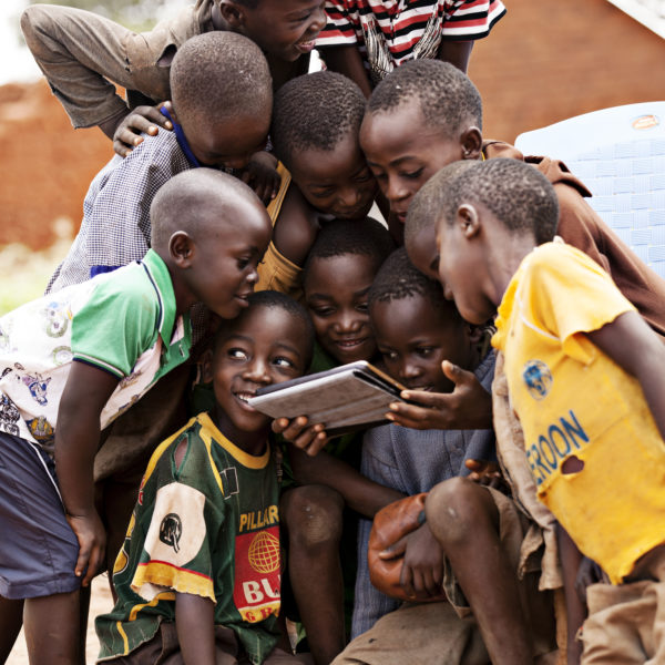 Children from Tanzania, enjoying the internet on a tablet